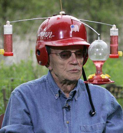 Obit of the Day: Inventor of the “Hummer Helmet”
David Leslie was a stockbroker by trade but his true love was nature. He and his wife, Mary, owned a cabin in northern Wisconsion which had a plethora of hummingbirds. Although they enjoyed watching the birds up close at feeders set up outside the house, it wasn’t quite close enough for Mr. Leslie.
So he invented the “Hummer Helmet.” The design was basic: a baseball helmet with three hummingbird feeders attached. Wearers of the helmet would be able to observe hummingbirds from the distance of 6 to 18 inches. 
The helmet led to appearances on KSTP-TV and Animal Planet. But the breakthrough came when David Letterman invited Mr. Leslie onto The Late Show. Mr. Leslie stayed in Minnesota while Mr. Letterman spoke to him via satellite. He would share periodic hummingbird updates throughout the show.
Mr Leslie, who owned patent #5996127 for the Hummer Helmet, died on February 5, 2013 at the age of 84. 
Sources: Minneapolis Star-Tribune, Minnesota Public Radio and his patent
(Image of Mr. Leslie wearing his invention during his Late Show appearance is courtesy of the Star-Tribune)
Obit of the Day has featured several inventors. You can find them here.