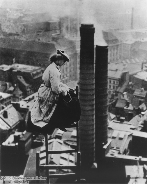 A Female Mason Perched High above Berlin (c. 1910)<br /><br /><br />
With the rise of industrialization, the number of German women who worked outside the home also increased. This usually meant factory work. But in some families with their own businesses, daughters also learned a trade so that they could help out: here, we see a master-mason’s daughter during the renovation work on the old city hall tower in Berlin. via GHDI 